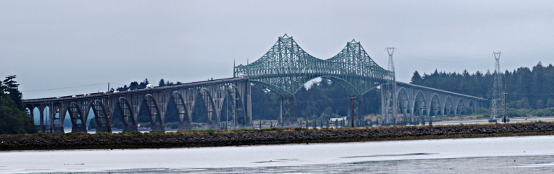 [Several photos stitched together giving a side view of the multi-arched bridge and the long ramps (with arches supporting them) leading to and from the bridge.]